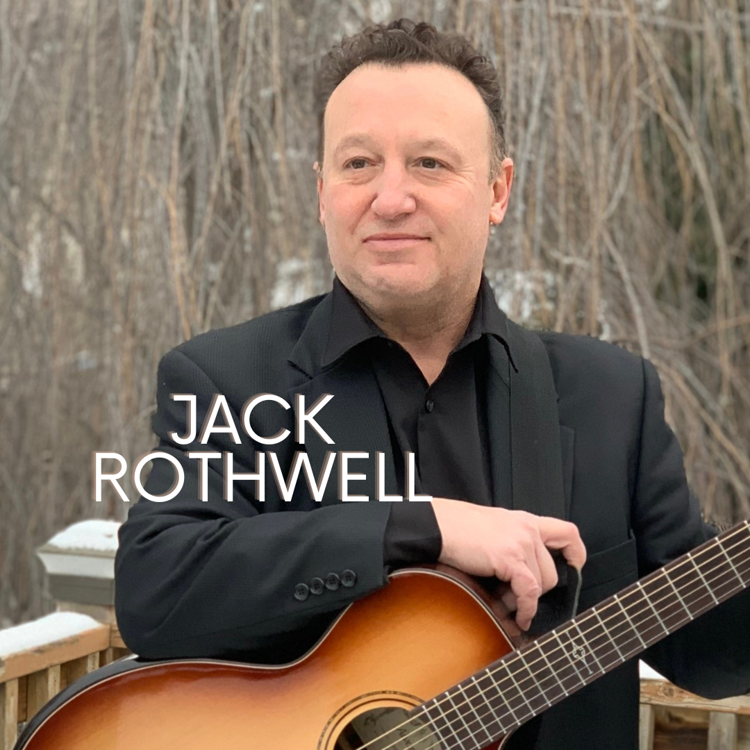 Man in black suit holding acoustic guitar outdoors, with Jack Rothwell text over the image.