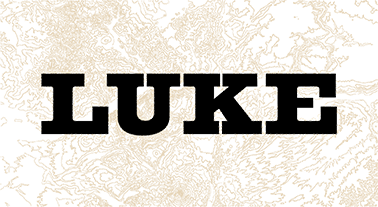 The word LUKE in bold, black, block letters on a beige and white textured background.