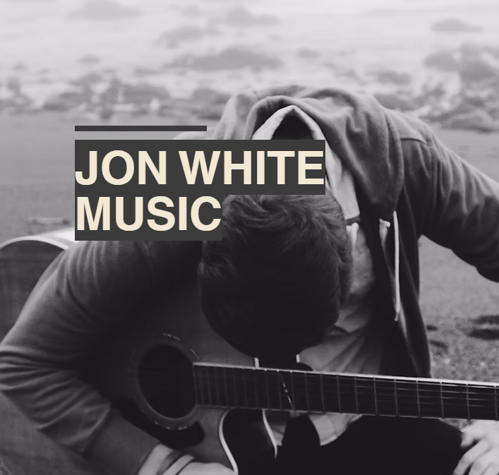 A person with a guitar sits on the beach with head bowed, text reads JON WHITE MUSIC.