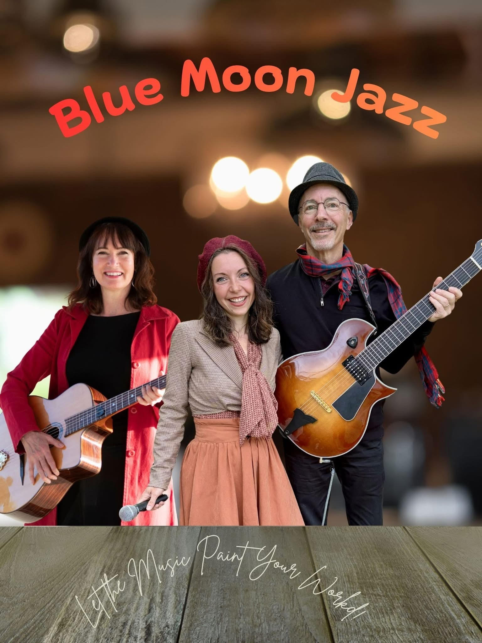 Three smiling musicians with guitars and a violin perform under &ldquo;Blue Moon Jazz&rdquo; text on a warmly lit stage, capturing the energy of live music Woodinville.
