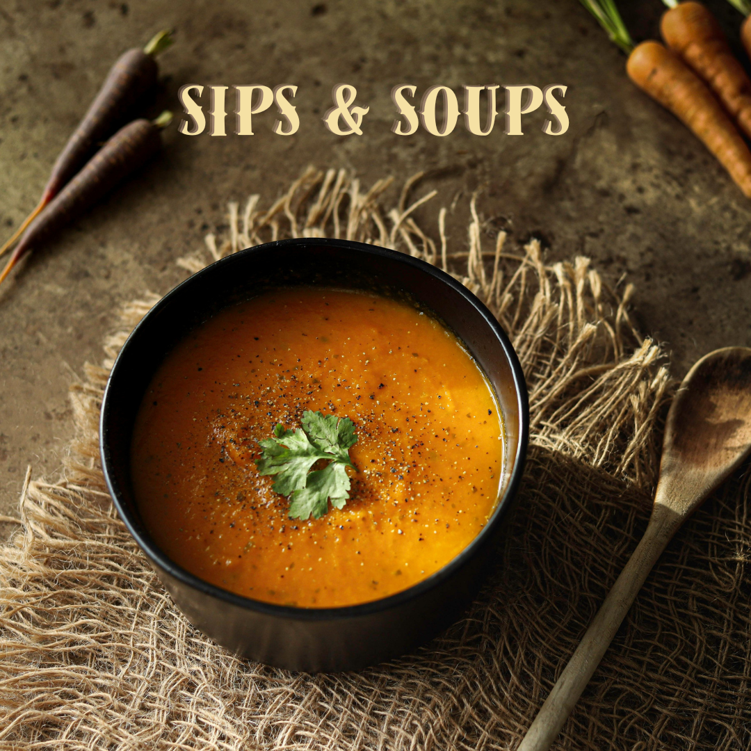 A bowl of orange soup garnished with herbs, beside carrots and a wooden spoon, with Sips & Soups text above.
