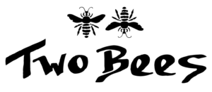 Two black bee illustrations above the words Two Bees in bold, stylized script.