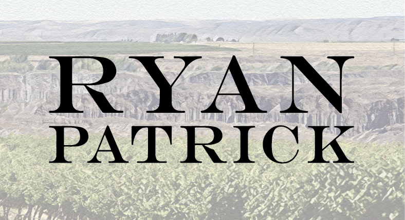 Large black text RYAN PATRICK over a background of vineyards and a distant landscape.